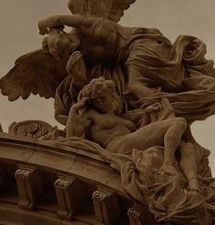 an angel statue on top of a building