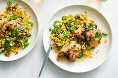 two white plates topped with chicken and corn