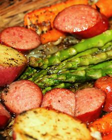 sausages, asparagus and potatoes in a pan