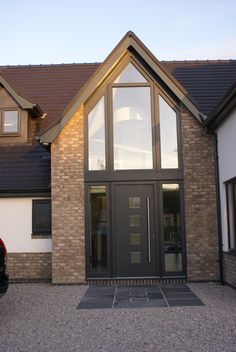 a house with a car parked in front of it and two windows on the side