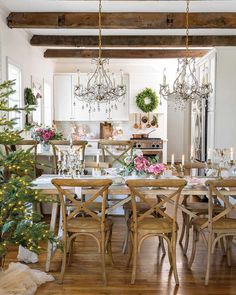 a dining room table with chairs and christmas decorations on the table in front of it