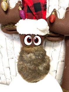 a close up of a stuffed animal wearing a santa hat