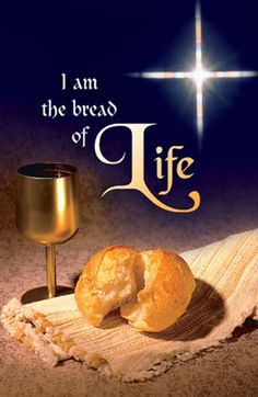 the bread is next to a wine glass and a chalice on a cloth with an inscription i am the bread of life