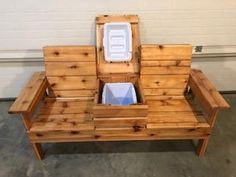 a bench made out of wood with a cooler in the seat and an ice chest on top