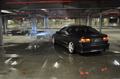 a black car parked in a parking garage