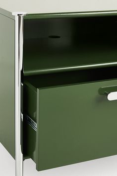 a green filing cabinet with two drawers on one side and an open drawer on the other