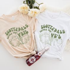 two t - shirts that say scott and the beanie boys with cactus designs on them next to a bottle of booze