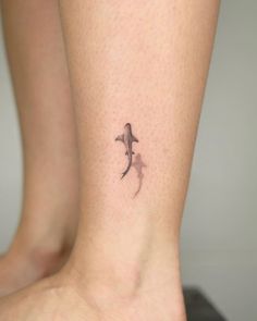 a small tattoo on the ankle of a woman