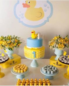 a table topped with lots of cakes and cupcakes