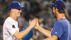 two baseball players giving each other a high five