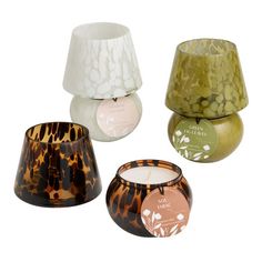 four different types of candle holders on a white background, including one with an animal print design