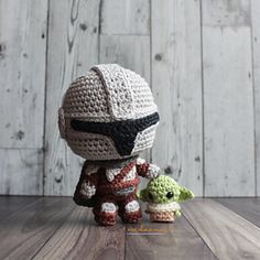 a crocheted star wars bobble head figure next to an amigurt baby yoda