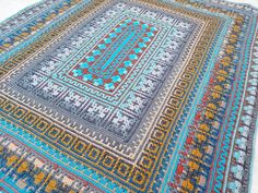 a multicolored rug is laying on the floor