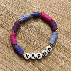 a beaded bracelet with the word karma written on it