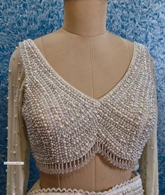 This Made to Order/Made to Measurement/Custom Made Indian Ethnic Blouse. - Fabric - Shimmer Georgette - Color - Champagne - Fully Hand Embroidered Beads and Sequins Work - Full Length Sleeves - Padded - Deep V Neck  - Back Hook Closure  - Princess Cut - Shoulder Strings with Latkans - Beads Fringes around the waist PLEASE NOTE: BUYERS ARE RESPONSIBLE FOR ANY CUSTOMS AND IMPORT TAXES THAT MAY APPLY.  This is a made to order product. If you opt for 'Made To Measurement Option', we will provide a measurement template and you can share the measurements likewise. If you want to opt for 'Standard Size', Please refer to the size chart provided in the listing. Shipping: Standard Shipping is done by DHL ecommerce and it mostly takes 2 to 3 weeks to deliver after dispatch. Express Shipping is done b Beads Blouse Design, Beads And Sequins Embroidery, Embroidered Beads, Saree Lehenga, Embroidered Saree, Beaded Blouse, Lehenga Blouse, Color Champagne, Stylish Work Outfits