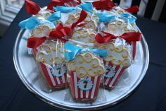 decorated cookies in red, white and blue are on a platter with ribbon bows