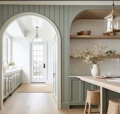 an archway leads to the kitchen and dining room