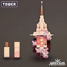 the tower is made out of legos and has pink flowers on its top, along with other accessories