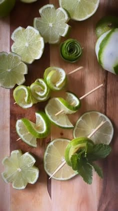 limes and limeade on a cutting board with toothpicks in the middle