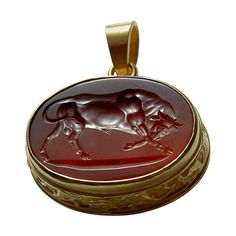 This exquisite intaglio is masterfully engraved onto carnelian gemstone and features a depiction of a bull. The stone is set in a 18K karat gold pendant. Production time for this piece is up to 10 weeks. Price does not include chain. Chavdar Chushev is an artist, restorer, jeweler, and master of the ancient art of gem carving. His extensive knowledge of gemstones and precious metals is complimented by a familiarity with more unusual materials, such as exotic woods, organic gems, and fossils. This unparalleled expertise accumulated over 40 years and distinct creative vision have made him one of the most respected jewelry designers in his field. Elaborately carved gems (intaglios & cameos) were a staple of luxury in antiquity and often incised onto semi-precious stones such as carnelian or j Gem Carving, Art Ancien, A Bull, Carnelian Beads, Modern Necklaces, 925 Sterling Silver Chain, Gold Art, Modern Pendant, Ancient Art