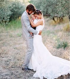 a bride and groom embracing in an olive grove