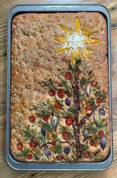 a christmas tree made out of bread on top of a wooden table next to a knife