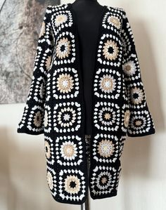 a black and white knitted jacket on a mannequin