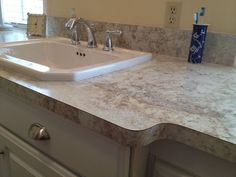 a white sink sitting on top of a counter