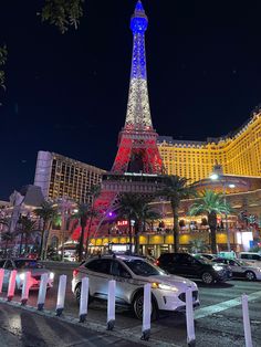 the eiffel tower is lit up in red, white and blue