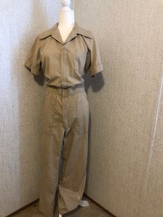 Fantastic vintage Casual Suits work/mechanic coveralls. Tan color, zip up front, staining shown in above photos, yet adds to over all aesthetic. Estimated size-Small Great condition, lightly worn.  Very unique piece. If you are unsure of size and fit, feel free to ask for measurements. Retro Jumpsuits And Rompers With Pockets, Retro Short Sleeve Jumpsuits And Rompers With Pockets, Affordable Vintage Workwear Bottoms, Vintage Fall Workwear Bottoms, Mechanic Outfit Female, Vintage Jumpsuits And Rompers For Workwear, Mechanic Outfit, Retro Style Workwear Overalls And Rompers, Vintage Denim Overalls For Work