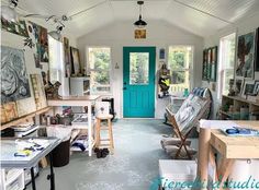 an artist's studio with lots of art work on the walls