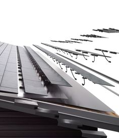 an array of metal beams and wires on the side of a building with white sky in the background