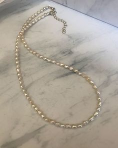 This beautiful and dainty necklace is strung with genuine freshwater rice pearls and finished with a sterling silver clasp. It is 16 1/2" with a 2" extender chain. Delicate Silver Beaded Necklace With Pearl Charm, Dainty Silver Beaded Necklace With Pearl Chain, Sterling Silver Pearl Necklace With Pearl Drop, Dainty Everyday Beaded Pearl Necklace, Sterling Silver Pearl Necklace With Round Beads, Dainty Pearl Beaded Necklaces In Silver, Dainty Silver Pearl Beaded Necklaces, Everyday Silver Single Strand Pearl Necklace, Dainty Silver Pearl Beaded Necklace