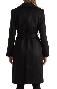 A super soft wool and cashmere blend composes this belted coat for cozy style. 40" length Long sleeves Front closure 95% wool, 5% cashmere Dry clean Made in USA
 Model stats: 5'10" height, 32" bust, 25" waist, 36" hip. Black Belted Wool Coat For Fall, Classic Fitted Outerwear With Belt Detail, Fitted Black Belted Wool Coat, Belted Wool Coat For Business, Black Belted Wool Coat For Winter, Formal Black Belted Outerwear, Formal Black Outerwear With Belt Detail, Long Sleeve Black Wool Belted Coat, Belted Long Wool Pea Coat