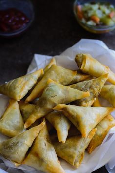 some food is sitting on a white plate and it looks like they have wontons in them