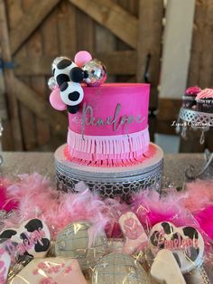 a pink and silver cake with minnie mouse decorations