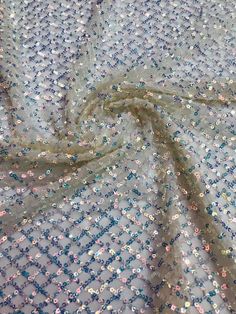 We offer a variety of fashion handmade fabric，those are widely use for wedding dress，garment and fashion cloth. we sell it by yard，our minimum order is 1 yards，and we always package it 15 yards for one roll，the width is about 130cm/50 inch Material ： tulle ,pearls, beads ,Rayon,polyester. Symmetrical embroidery floral pattern, with lovely flowers in the middle, scalloped border. You can also cut and use separately. Perfect for dress, tops, wedding veil. You can split the piece up and have one sc Fitted Sequined Embroidered Fabric For Summer, Sequin Net Party Dress, Sequin Net Dress For Party, Glamorous Net Dress With Sequins, Glamorous Summer Wedding Sequin Fabric, Party Dress With Sequins On Net Material, Party Dress With Sequins On Net, Festive Party Sequin Lace Fabric, Sequin Fabric With Lace Work For Festive Party