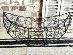 a metal basket sitting on top of a rug