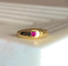 "\"Be Mine\" Dainty Pink Heart Stone Signet Ring with Ruby Cubic Zirconia Crystal. This ring shouts LOVE and PASSION in the most subtle way possible!💞 So simple and sensual ✨The PERFECT dainty LOVE Ring! Ways to Wear: Pinky finger and Index finger💞 Ruby Represents: Love, Energy, Passion, Power, and Zest of Life💖 Handmade Item 💕😊 ENJOY ! Material 18K-Gold Plated over Solid Sterling Silver Gemstone: Cubic Zirconia Lead & Nickel free Details Ruby Cubic zirconia (Red/Pink) Diamond cut stone Ring With Ruby, Pinky Finger, Ruby Heart, Gold Heart Ring, Swarovski Crystal Hearts, Ring Ruby, Stamped Rings, Ring Heart, Heart Stone