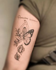 a woman with a tattoo on her arm has a butterfly and flowers tattooed on it