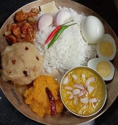 a plate filled with rice, eggs and other foods