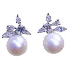 Elevate your look with this exquisite pair of South Sea Pearls and Diamonds earrings. Designed with particular attention for details , and crafted with meticulous goldsmith' art . Adds a touch of class and charm with this sophisticated earrings. Stunning earrings come in 18k gold with two Luxurious South Sea Pearls , extra fine quality, pure white color, of about 12mm , and Natural Diamonds, in mixed special cut, of 1,65 ct, F-G color VS clarity, very sparkly. Complete with report. Handcrafted y Elegant Gia Certified Pear Earrings, Gia Certified Pear Shaped White Gold Earrings, Pear-shaped Gia Certified White Gold Earrings, Sophisticated Earrings, Diamonds Earrings, Golden South Sea Pearls, 18k Gold Earrings, Pearl And Diamond Earrings, Contemporary Pendant