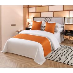 an orange and white bed in a bedroom