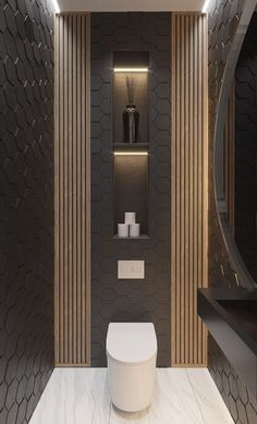 a modern bathroom with black and gold accents on the walls, along with a white toilet