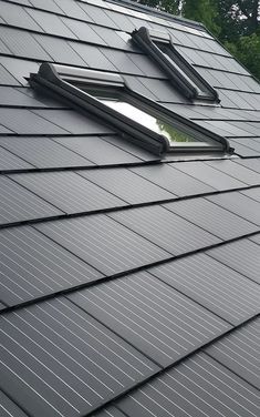 two solar panels on the roof of a house