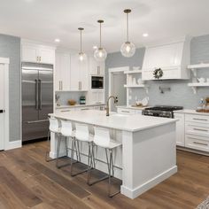 a kitchen with white cabinets and an island