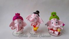 three small figurines of elephants sitting next to each other