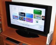 a flat screen tv sitting on top of a wooden entertainment center