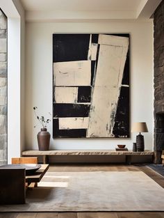 a living room filled with furniture and a large painting on the wall above it's fireplace