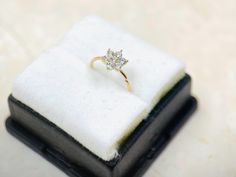 a diamond ring sitting on top of a black box